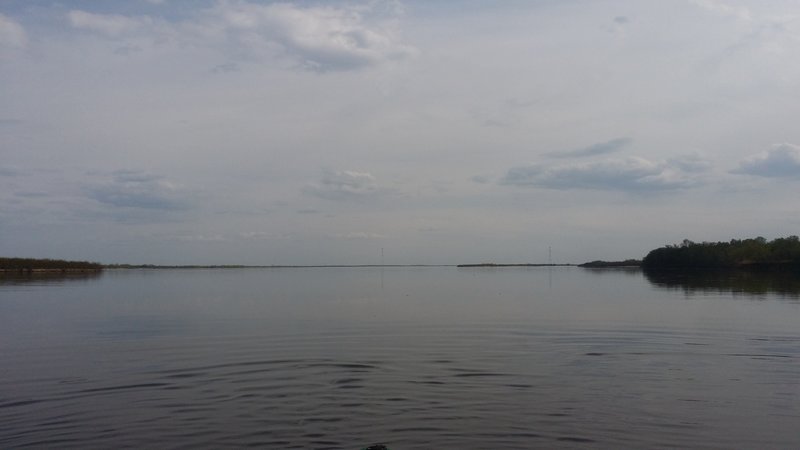 Прошли наконец длинный остров, видим реку во всей красе. Вода спокойная, тихая, как на озере. Вдали виднеются опоры ЛЭП, время 16:15.