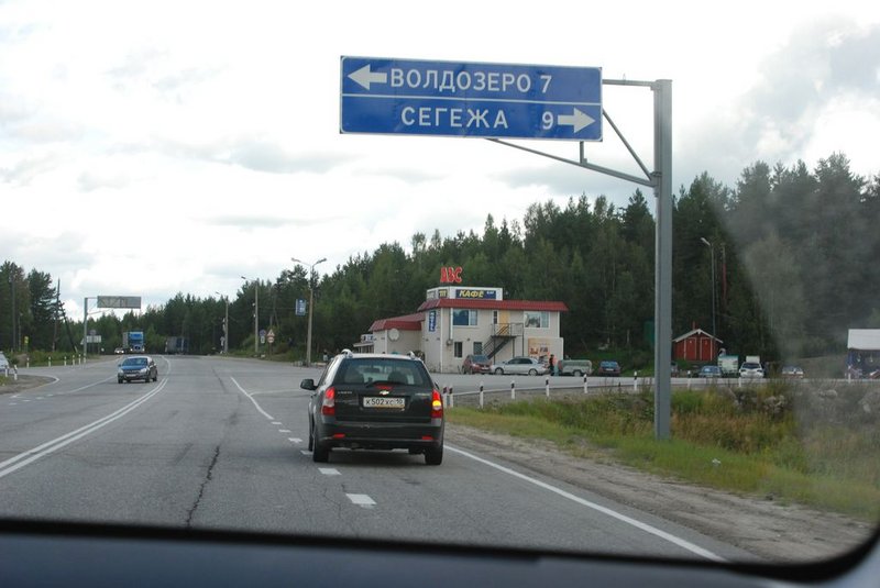 Едем дальше. До поворота на Кузему остаётся порядка 200 км. Уже начинаем беспокоится насчёт грунтовки между трассой М18 и этой самой Куземой. В каком она сейчас состоянии? За неделю до нашей поездки в Карелии было сильное наводнение, были размыты железнодорожные пути, подтоплены некоторые населённые пункты. И всё это как раз в том районе, куда мы едем. Костик предлагает вместо Куземы забросить меня в Кемь. Там асфальтовая дорога прямо до моря. Но мне как-то в Кемь не хочется, т.к. в этом случае мой водный маршрут станет слишком длинным, а график слишком напряжённым. Да и плавали мы уже между Кемью и Куземой, второй раз делать там нечего. Звоню Алексею, который живёт в Беломорске, и который нас в 2010-м забрасывал в Кузему по этой грунтовке. Алексей сообщает, что телевидение по части наводнения сильно сгустило краски, у них в Беломорске всё в порядке. По грунтовке до Куземы, говорит, доедем без проблем. Мы воспряли духом и поехали дальше. Едем дальше. До поворота на Кузему остаётся порядка 200 км. Уже начинаем беспокоится насчёт грунтовки между трассой М18 и этой самой Куземой. В каком она сейчас состоянии? За неделю до нашей поездки в Карелии было сильное наводнение, были размыты железнодорожные пути, подтоплены некоторые населённые пункты. И всё это как раз в том районе, куда мы едем. Костик предлагает вместо Куземы забросить меня в Кемь. Там асфальтовая дорога прямо до моря. Но мне как-то в Кемь не хочется, т.к. в этом случае мой водный маршрут станет слишком длинным, а график слишком напряжённым. Да и плавали мы уже между Кемью и Куземой, второй раз делать там нечего. Звоню Алексею, который живёт в Беломорске, и который нас в 2010-м забрасывал в Кузему по этой грунтовке. Алексей сообщает, что телевидение по части наводнения сильно сгустило краски, у них в Беломорске всё в порядке. По грунтовке до Куземы, говорит, доедем без проблем. Мы воспряли духом и поехали дальше. 